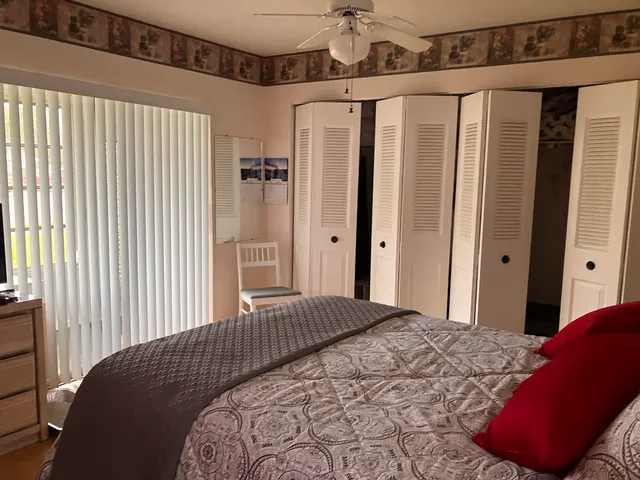 a bedroom with a bed window and walk in closet