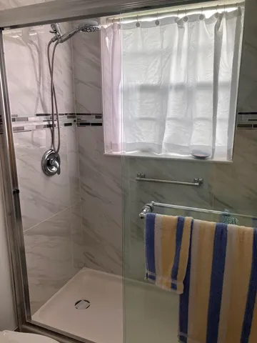 a bathroom with a shower and a sink