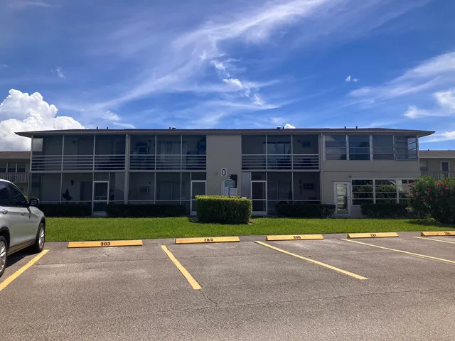 a view of a house with a swimming pool and sitting area