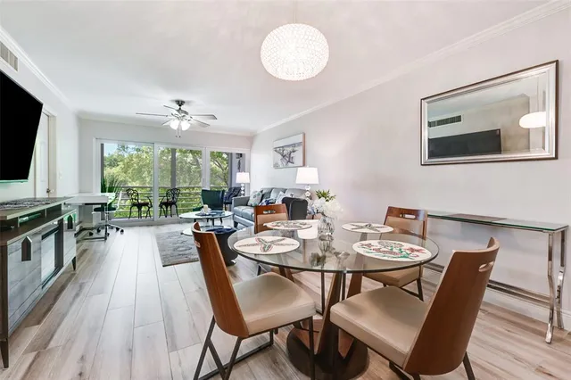 a view of a dining room with furniture window and wooden floor