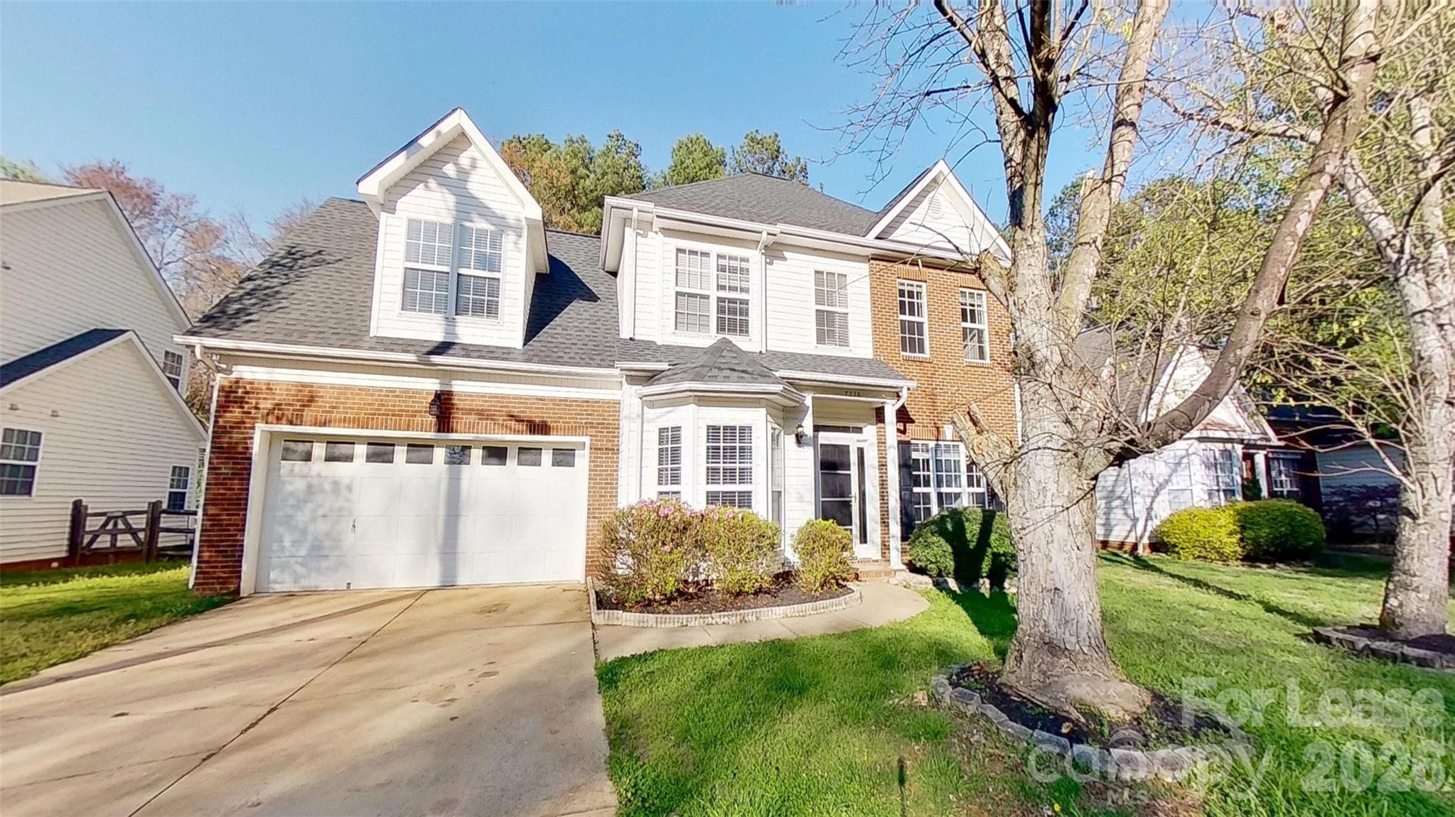 7236 Rock Island Road Charlotte, NC 28278 - Photo 1 of 11 a front view of a house with a yard and garage