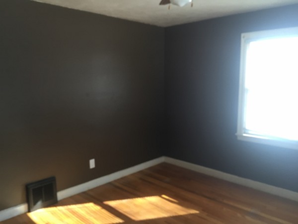 207 Edendale Street Springfield, MA 01104 - Photo 17 of 21 a view of empty room with wooden floor and fan