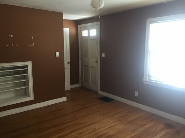207 Edendale Street Springfield, MA 01104 - Photo 8 of 21 a view of an empty room with wooden floor and a window