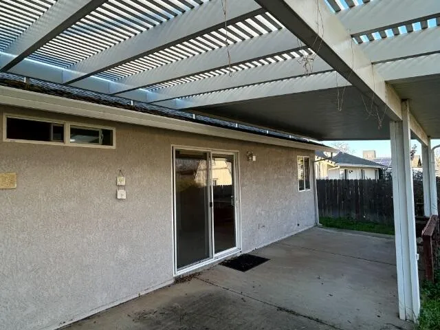 a living room with furniture and large windows