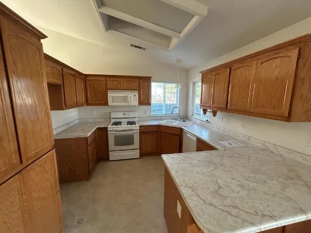 a kitchen with stainless steel appliances granite countertop a sink stove and microwave