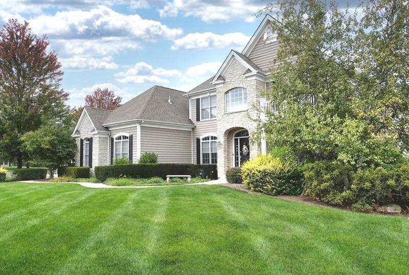 905 Lyons Ridge Drive Cary, IL 60013 - Photo 2 of 3 a front view of a house with a yard and garage