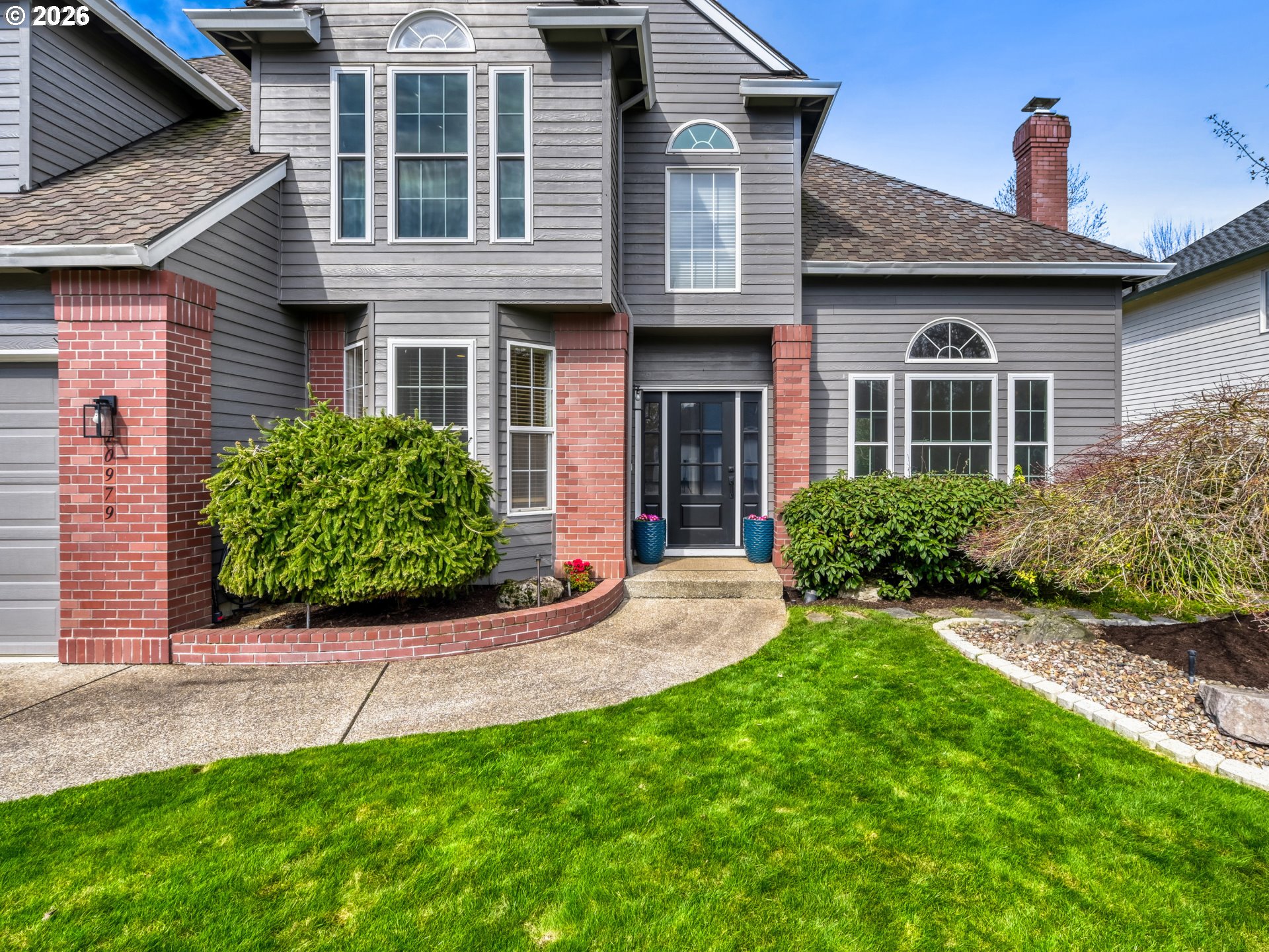 10979 Southwest Matzen Drive Wilsonville, OR 97070 - Photo 3 of 37 a front view of a house with a yard and porch