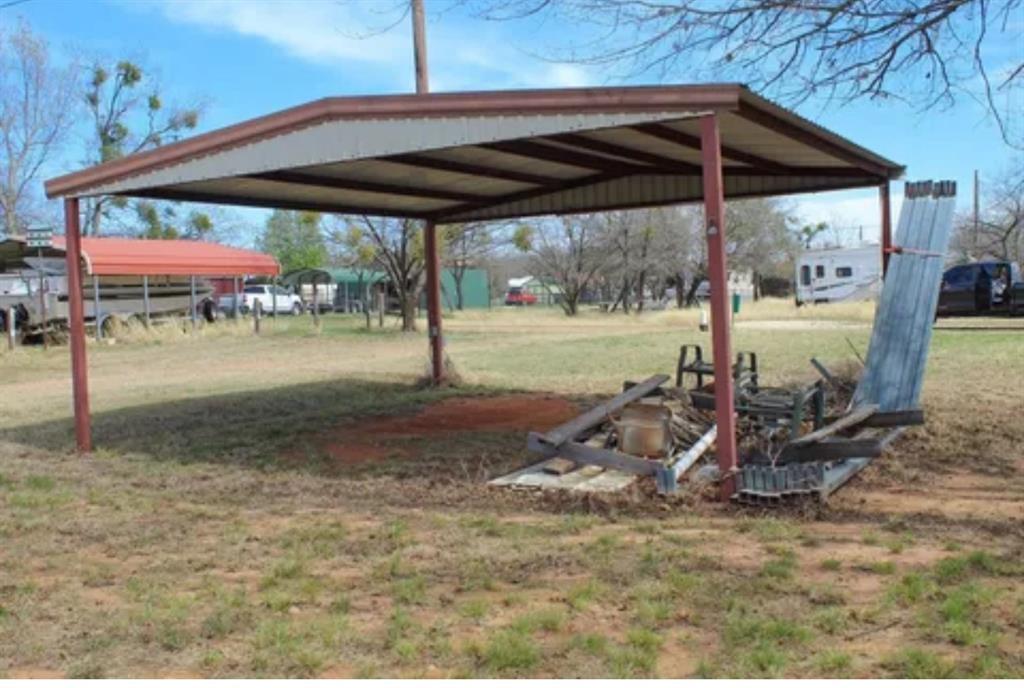 0 Ocho Rios Road Comanche, TX 76442 - Photo 4 of 10 a view of a patio with a table and chairs under an umbrella