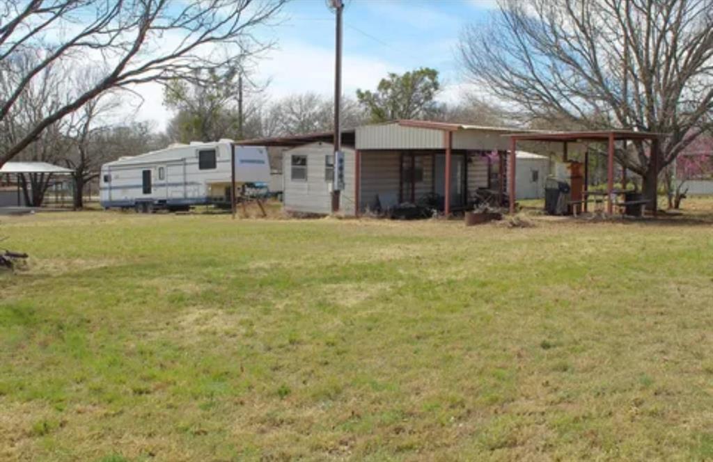 0 Ocho Rios Road Comanche, TX 76442 - Photo 7 of 10 a front view of a house with a garden and trees