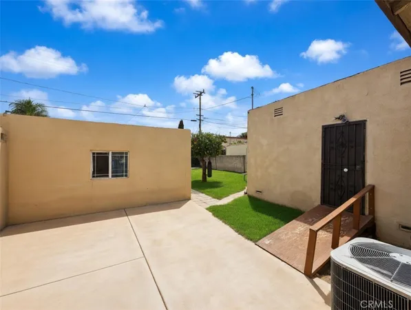 a front view of house with yard and outdoor seating