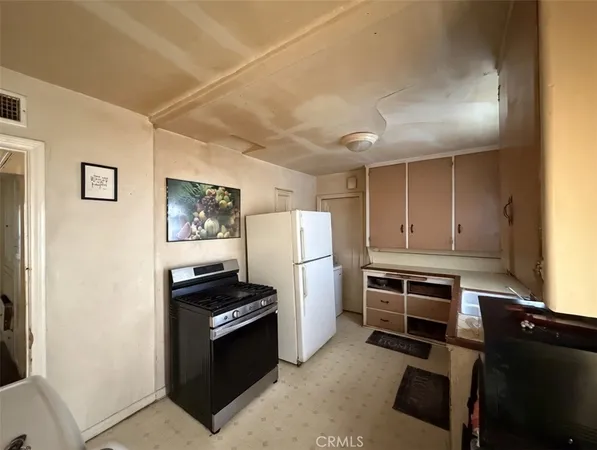 a kitchen with a refrigerator and a stove