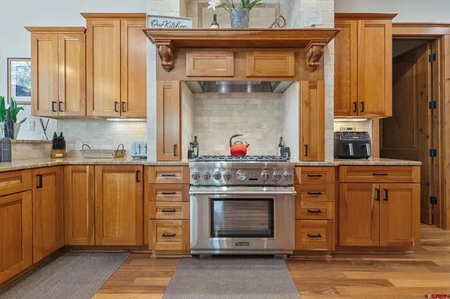 a kitchen with stainless steel appliances granite countertop a stove and a refrigerator