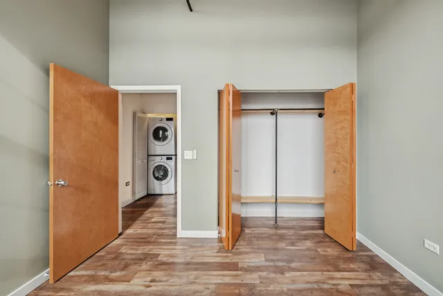 a view of a hallway with wooden floor and a cabinet