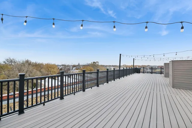 a view of a balcony with wooden floor