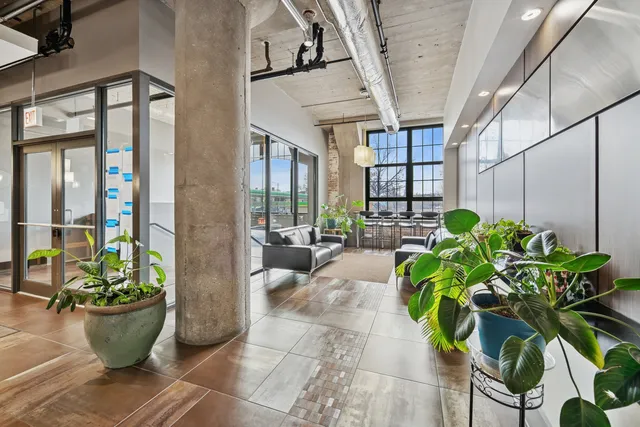 a vase of flowers sitting on a floor