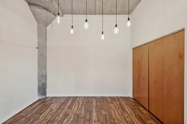 a view of a room with wooden floor