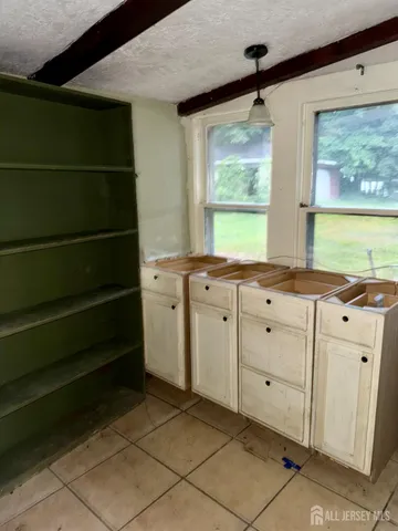 a room with a window and a dresser