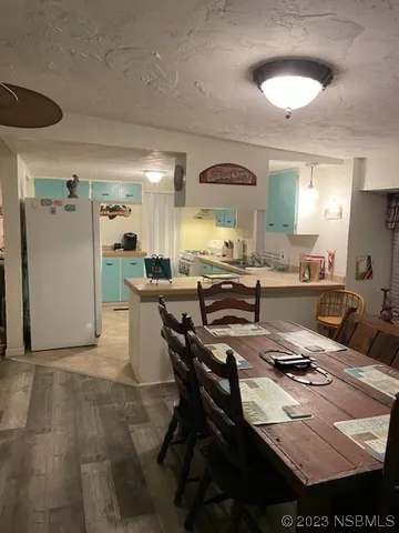 a kitchen with a sink and chairs