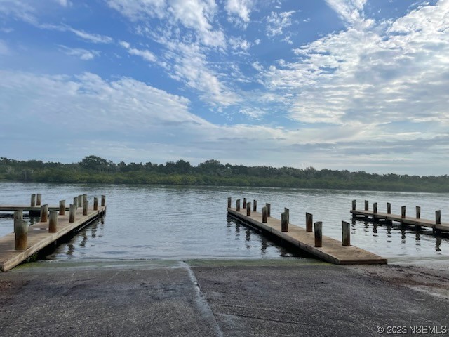 130 H H Burch Road Oak Hill, FL 32759 - Photo 22 of 24 a view of a lake with houses in the back