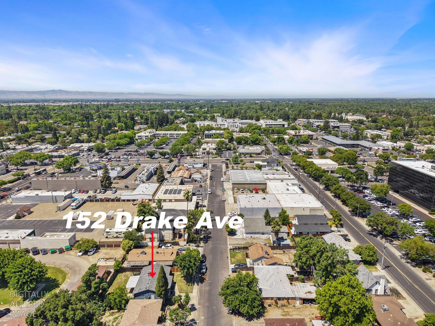152 Drake Avenue Modesto, CA 95350 - Photo 43 of 52 an aerial view of a city with lots of residential buildings in back and yard