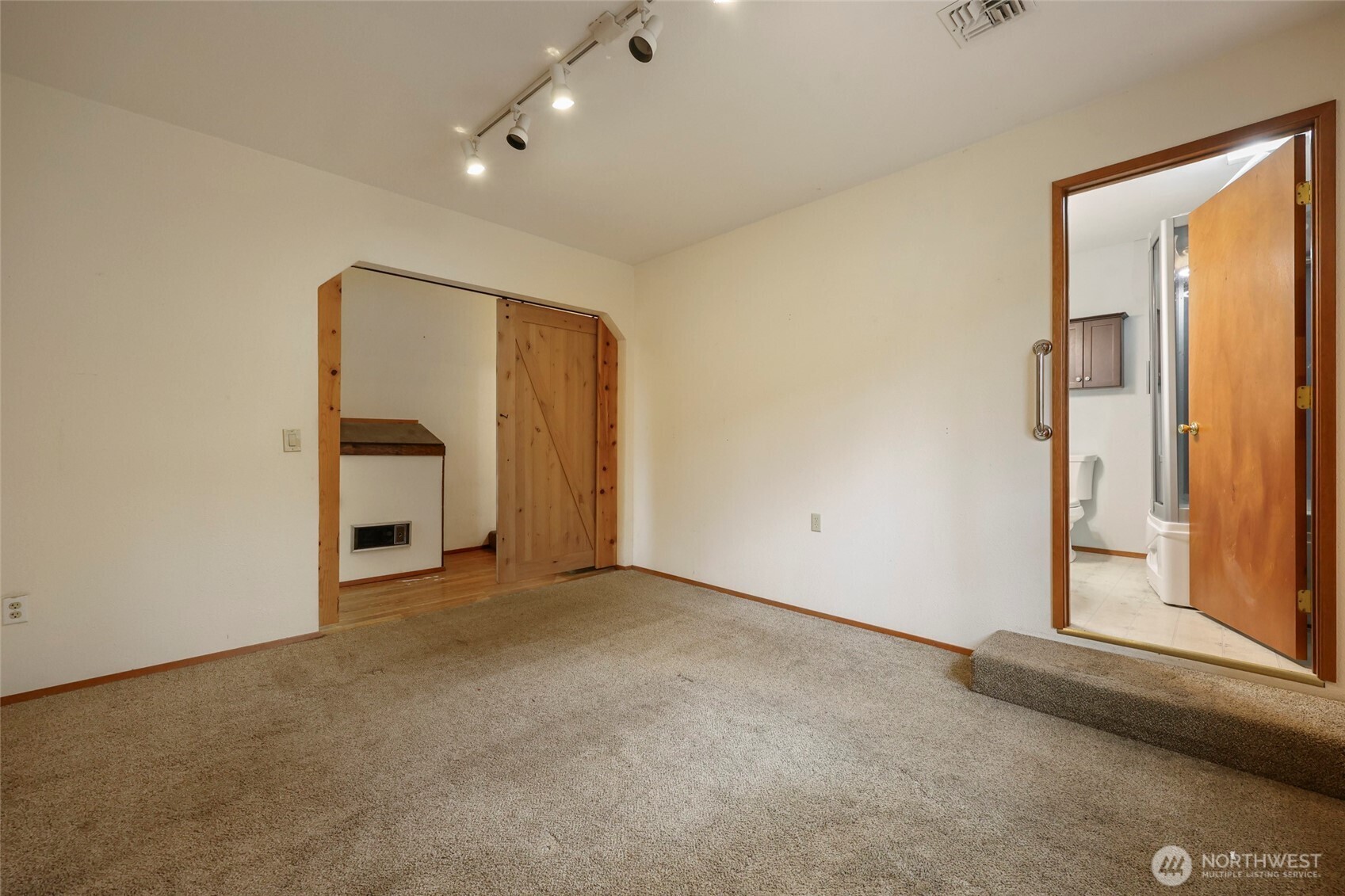 17215 Gibson Road Southwest Tenino, WA 98589 - Photo 11 of 40 an empty room with a fireplace and windows