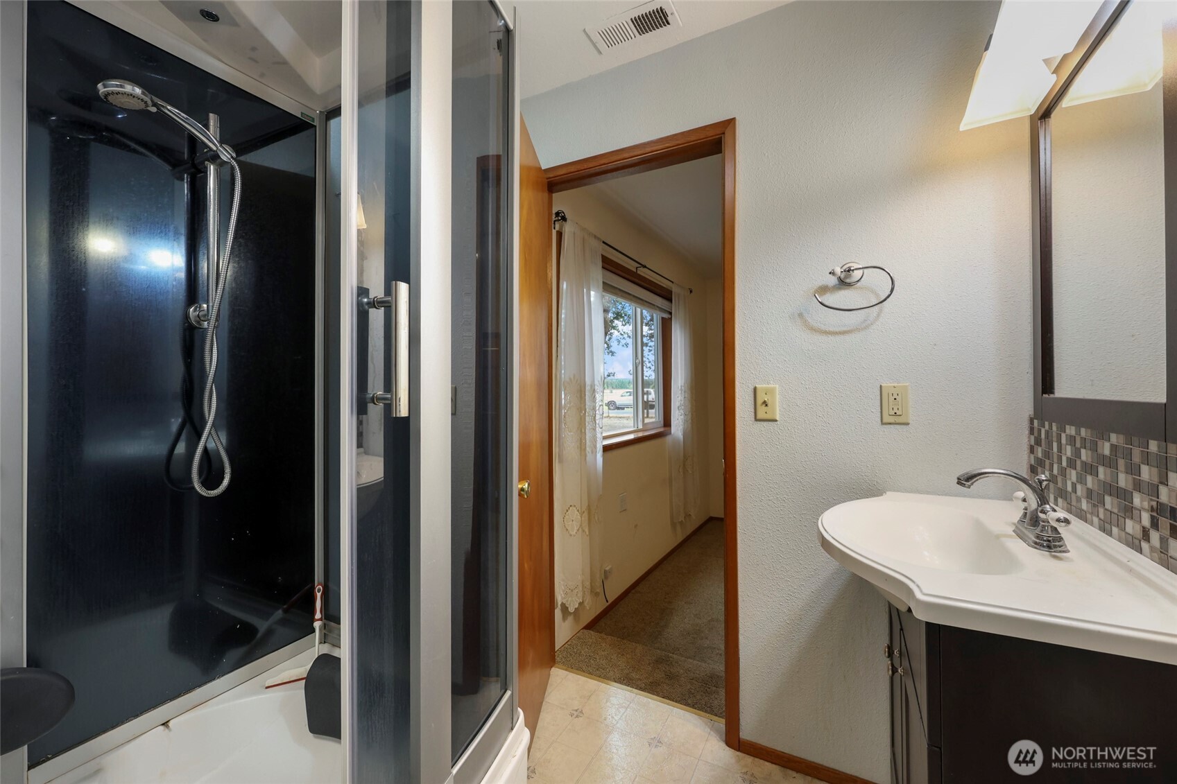 17215 Gibson Road Southwest Tenino, WA 98589 - Photo 15 of 40 a bathroom with a sink and a mirror