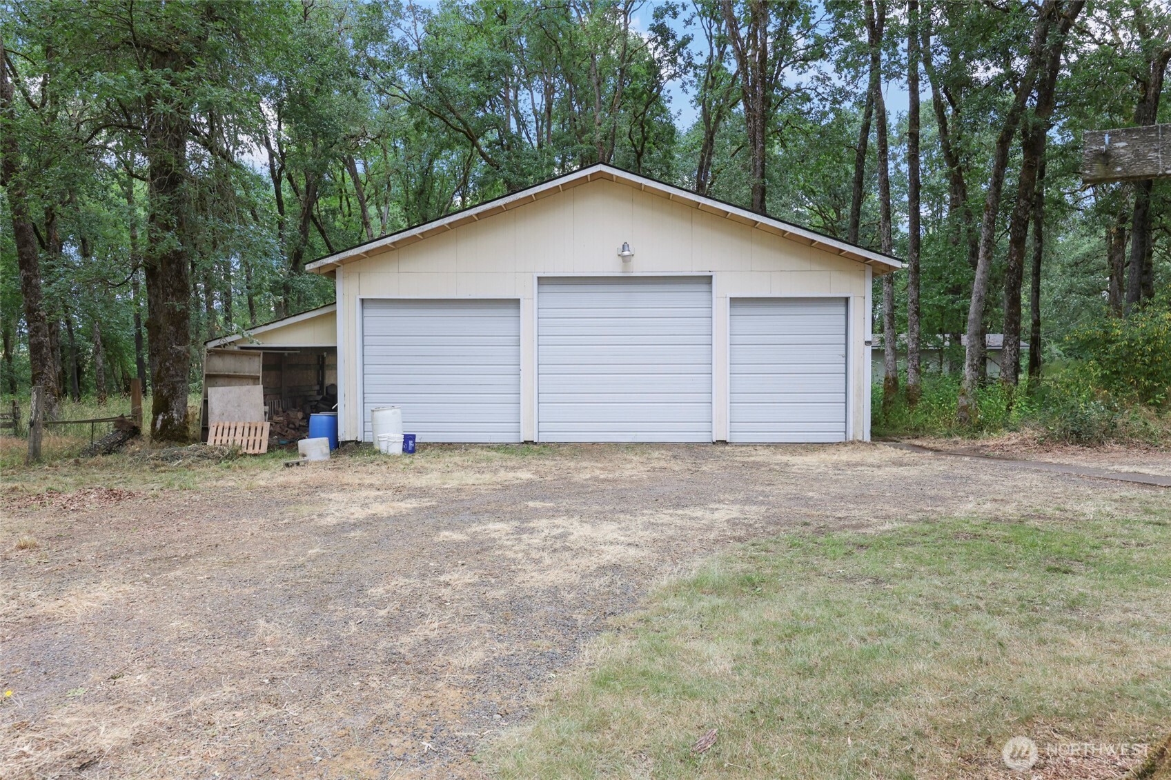 17215 Gibson Road Southwest Tenino, WA 98589 - Photo 26 of 40 a view of backyard of house and garage