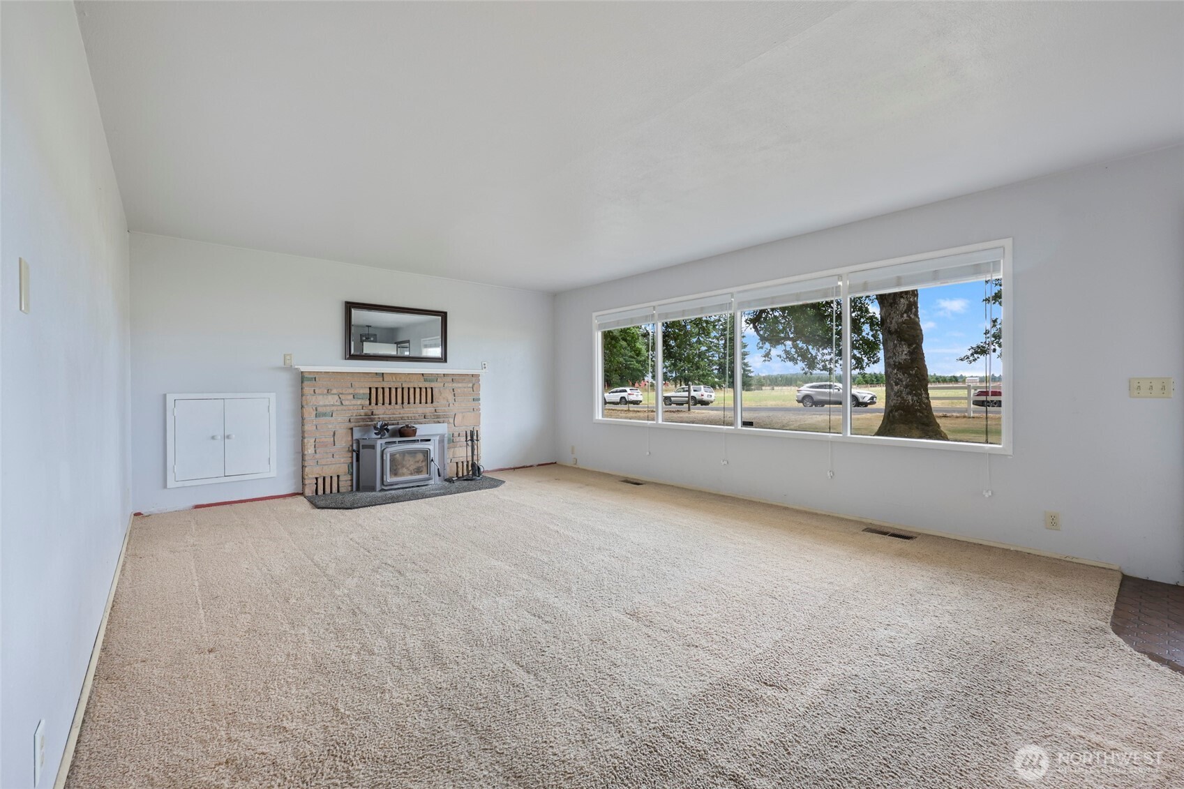 17215 Gibson Road Southwest Tenino, WA 98589 - Photo 7 of 40 an empty room with furniture and a fireplace