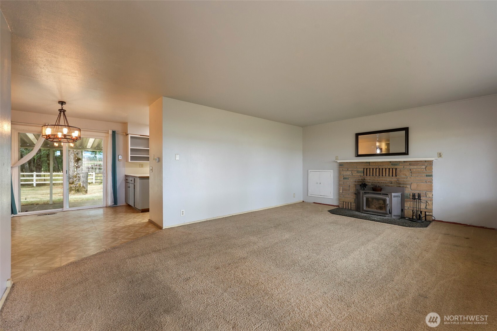 17215 Gibson Road Southwest Tenino, WA 98589 - Photo 9 of 40 an empty room with furniture and a fireplace