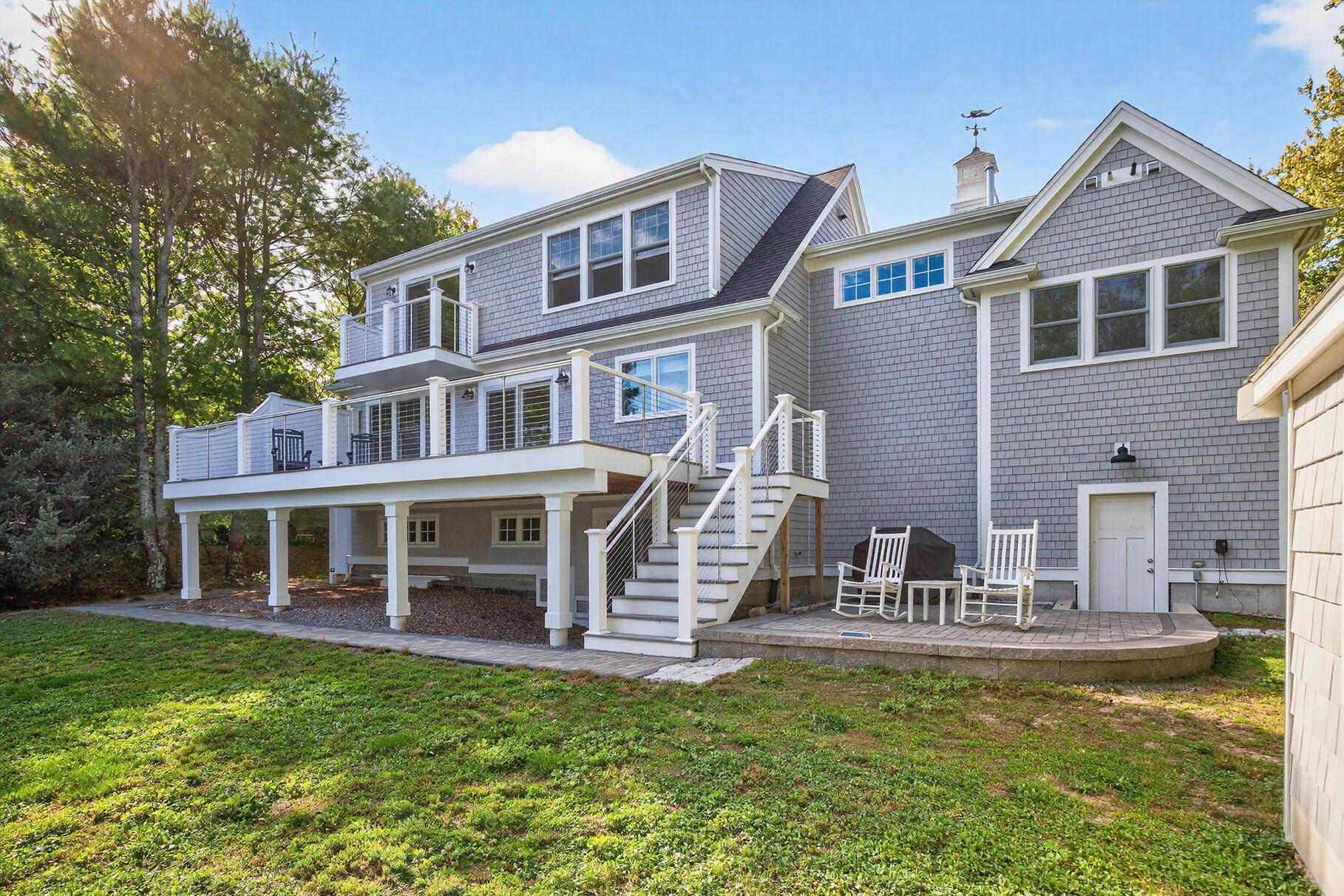 128 Uncle Percy's Road Mashpee, MA 02649 - Photo 31 of 45 a front view of a house with a yard table and chairs