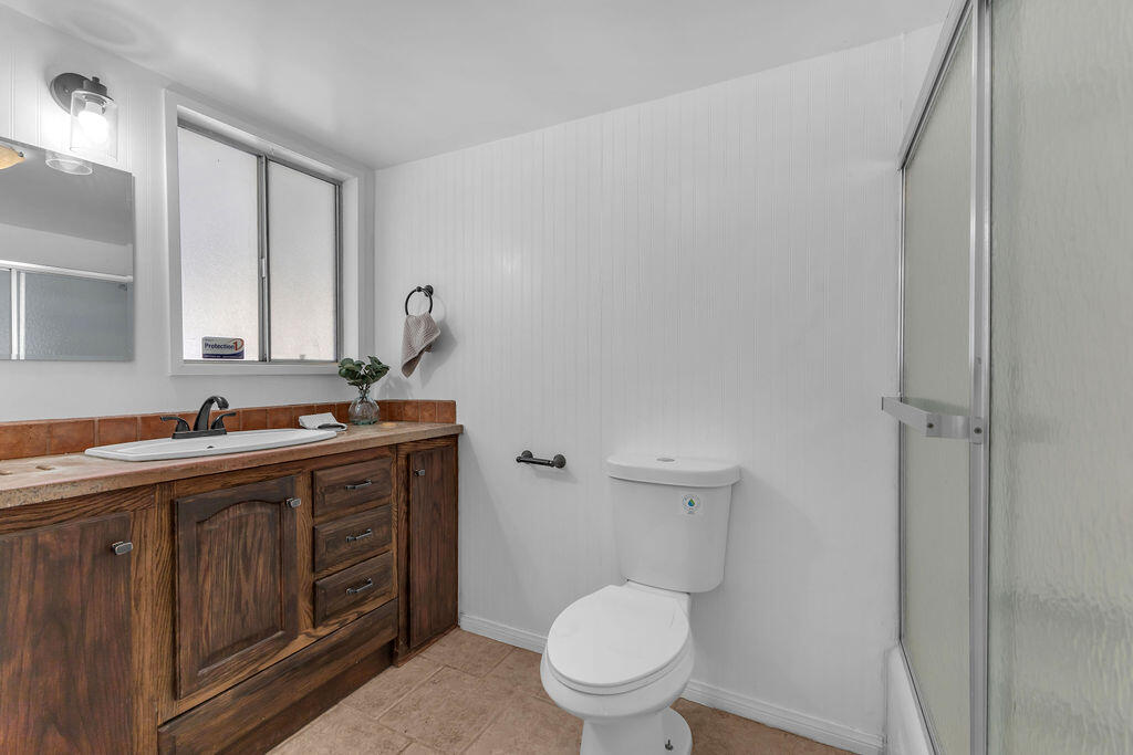 51088 Mecca Road Morongo Valley, CA 92256 - Photo 14 of 77 a bathroom with a toilet a sink and mirror