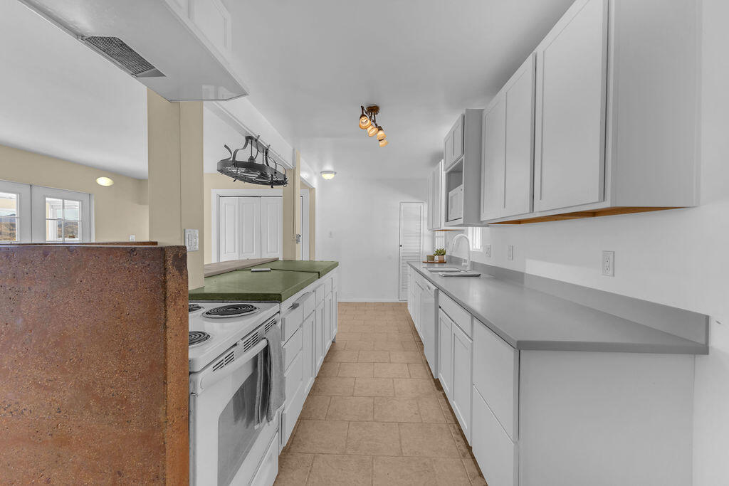 51088 Mecca Road Morongo Valley, CA 92256 - Photo 21 of 77 a kitchen with stainless steel appliances granite countertop a sink stove and refrigerator