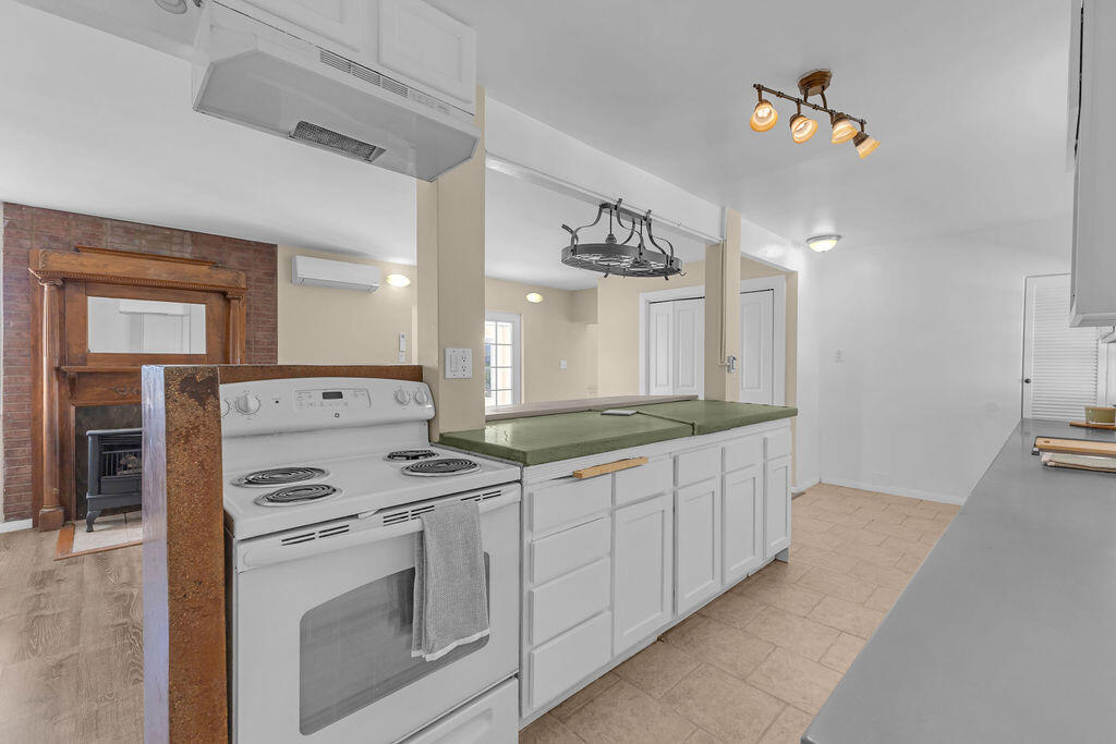 51088 Mecca Road Morongo Valley, CA 92256 - Photo 22 of 77 a kitchen with granite countertop white cabinets and white appliances