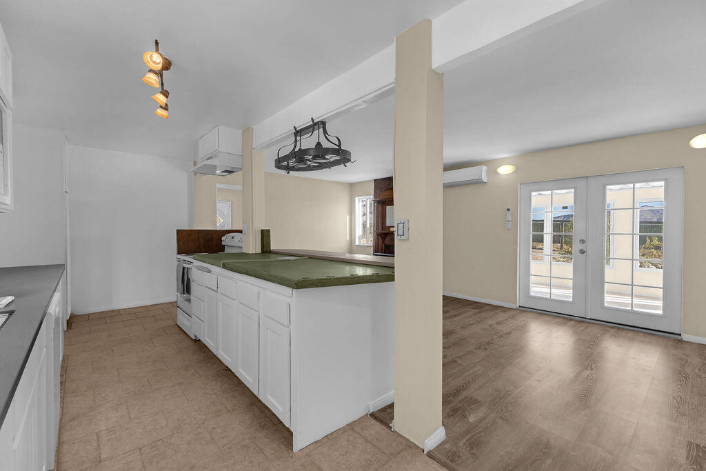 51088 Mecca Road Morongo Valley, CA 92256 - Photo 23 of 77 a kitchen with stainless steel appliances granite countertop a sink a stove and a wooden floors