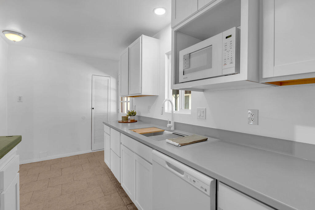 51088 Mecca Road Morongo Valley, CA 92256 - Photo 27 of 77 a kitchen with a sink stove and cabinets