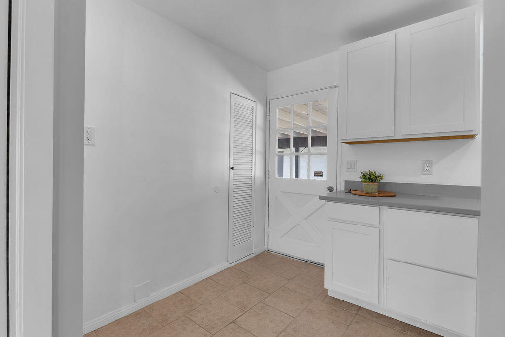 51088 Mecca Road Morongo Valley, CA 92256 - Photo 28 of 77 a kitchen with white cabinets and a sink