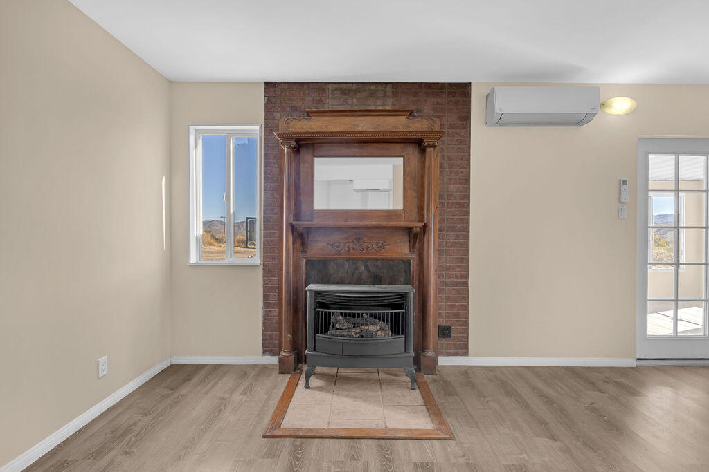51088 Mecca Road Morongo Valley, CA 92256 - Photo 30 of 77 a living room with a fireplace and a table
