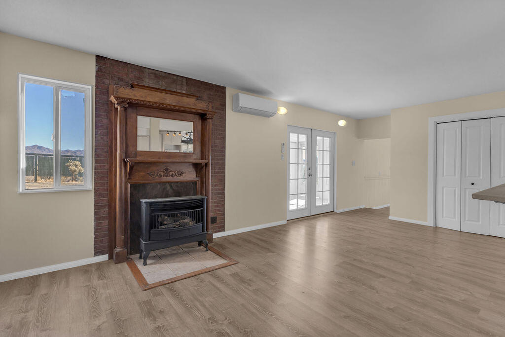 51088 Mecca Road Morongo Valley, CA 92256 - Photo 31 of 77 a view of an empty room with a fireplace and a window