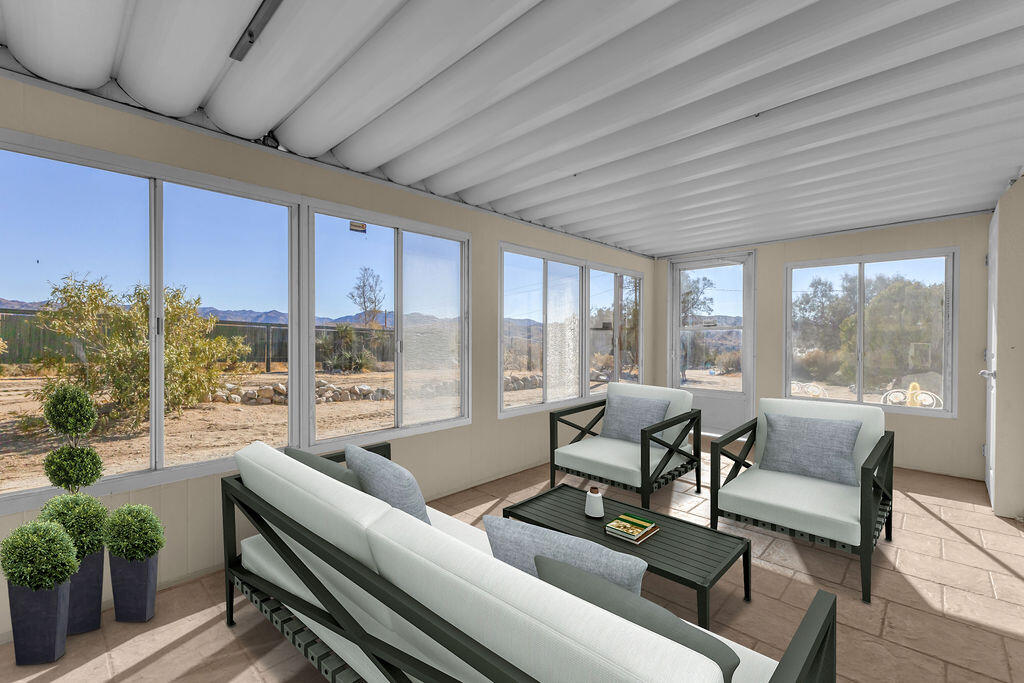 51088 Mecca Road Morongo Valley, CA 92256 - Photo 37 of 77 a living room with furniture and a floor to ceiling window
