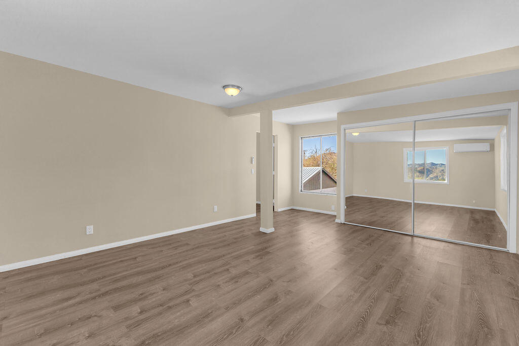 51088 Mecca Road Morongo Valley, CA 92256 - Photo 52 of 77 a view of an empty room with wooden floor and a window