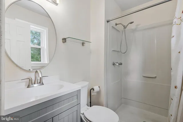 a bathroom with a toilet sink and shower