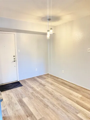 an empty room with a empty space and a ceiling fan