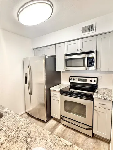 a kitchen with a stove microwave and refrigerator