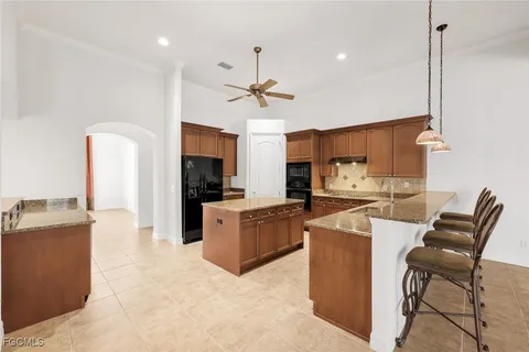 a kitchen with cabinets and chairs