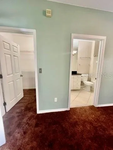 a view of empty room with window and ceiling fan
