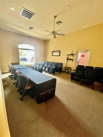 a living room with furniture pool table and window