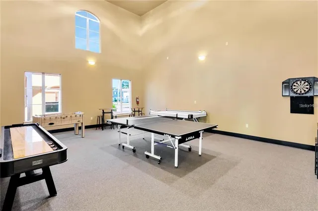 a living room with furniture chandelier and a flat screen tv