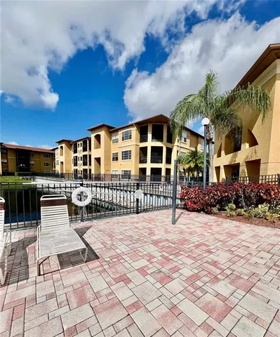 a view of swimming pool with outdoor seating and yard in back
