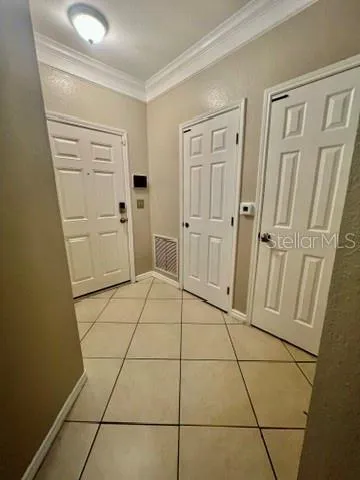 a kitchen with granite countertop a refrigerator and a stove top oven