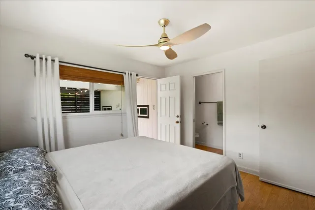 a bedroom with a large bed and a window